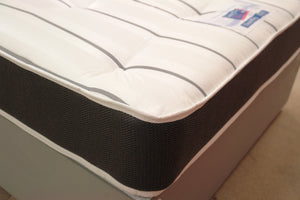 This corner view of the Superfirm 3000 Spring Mattress highlights the border in Dark Grey Herringbone fabric. Both sleeping surfaces are in high durability grey & white stripe, tufted damask fabric. The 12.5 gauge rod edged Bonnell spring unit, super compressed fillings & heavy duty double insulated pad all create an extra firm tension. 