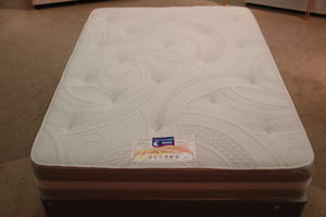 This top view of the Super Supreme Spring Memory Mattress highlights the heavy duty stretch knit fabric with Tufts which covers the 2" of Memory foam. It has a vented border and light grey damask fabric. It's dual season; medium tension on reverse with superior Belgian Damask fabric. 