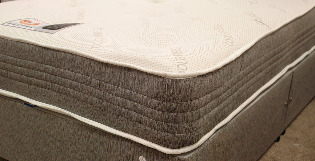 This Milan 1500 Pocket Memory Mattress corner view shows the side stitched border. It features 2" Memory foam which is turnable. The dual season reverse side is medium tension as standard. The heavy duty stretch knit fabric top has tufts.